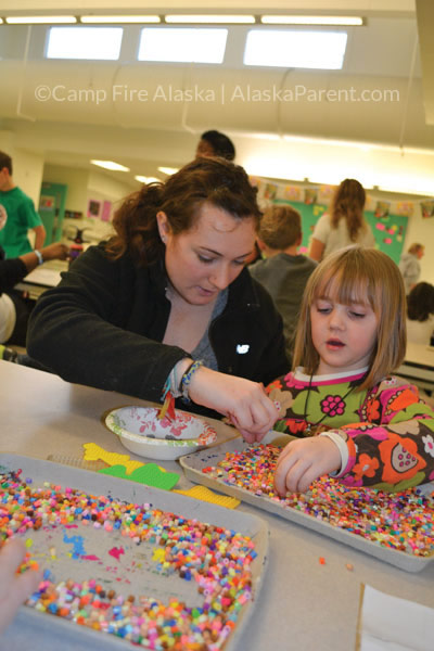A Camp Fire Alaska teacher and student crafting with perler beads during the Chugach Optional Before- and After-School Program.