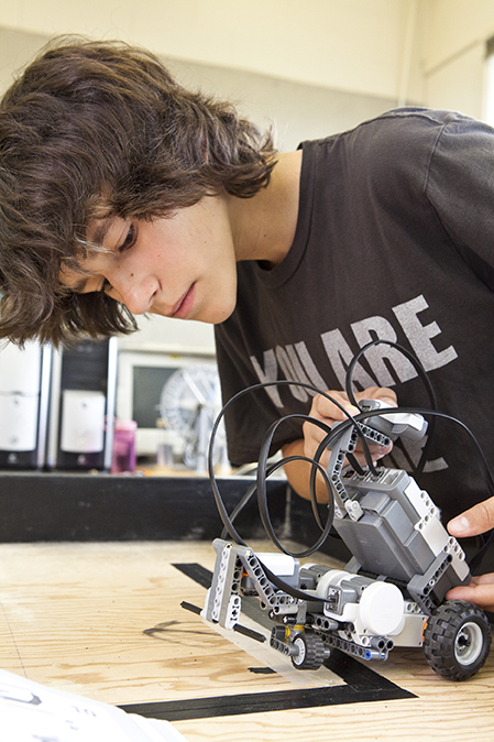 This teen camper explores robotics in Anchorage Museum's summer camp Robot Revolution